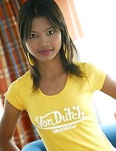 Tussinee posing in yellow shirt and short shorts
